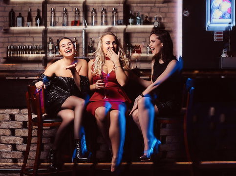 Cheerful female friends resting in the nightclub