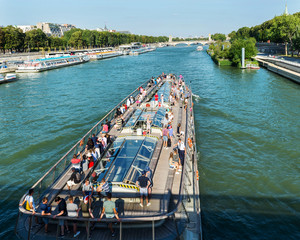 Pleasure boat with people sailing on the river Seine. Paris. France. 