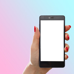 Female hand holding white mobile phone over pink background