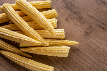 Pickled corn in a bowl. On rustic background