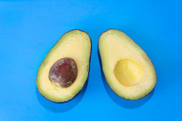 Avocado halves on colorful background