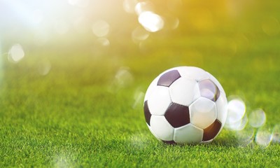 Close view of green football field with soccer ball