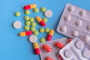 medicines and pills on blue background.