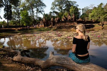 Mujer sentada viendo templo de Angkor en Camboya.