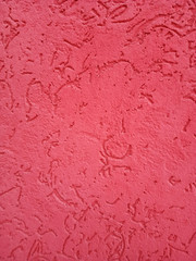 The texture of the stone wall painted with dry purple plaster.