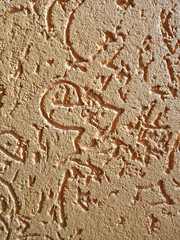 The texture of the stone wall painted with dry brown plaster.