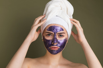 Close up portrait of young woman with towel on her head