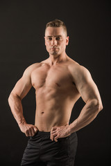 Fototapeta premium handsome muscular man on black background