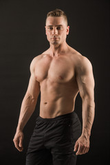 Fototapeta na wymiar handsome muscular man on black background