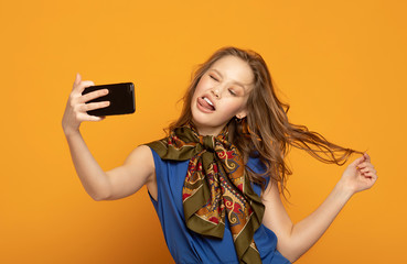 Pretty positive cheerful young woman making selfie