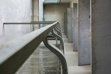 Old prison corridor with open cells.	