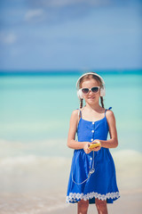 Fototapeta na wymiar Adorable active little girl at beach during summer vacation