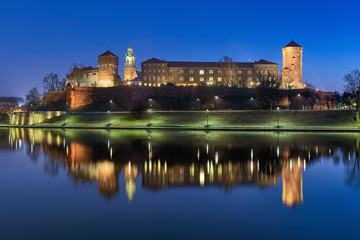 Krakow, Poland. Wawel Hill with Wawel Royal Castle and fragment of Wawel Cathedral at dawn. View from the bank of Vistula river.