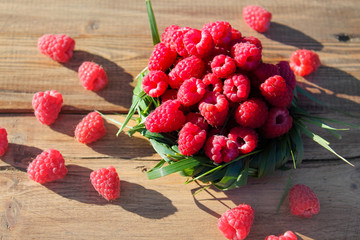 raspberries in a basket of grass