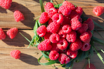 raspberries in a basket of grass