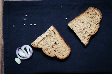 two pieces of rye bread on the tablecloth