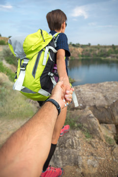 Couple on a hking tour near mountain lake holding hands