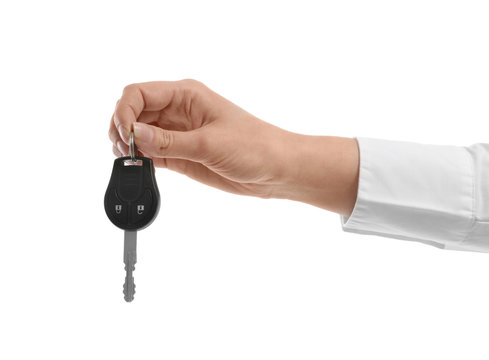 Woman holding car key isolated on white