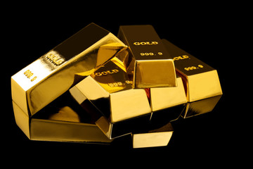 Many shiny gold bars on black background