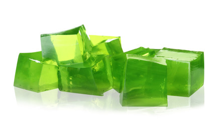 Heap of green jelly cubes on white background