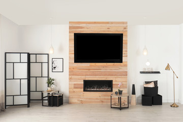 Living room interior with decorative fireplace in wooden wall