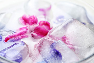 Glass with floral ice cubes and water, closeup
