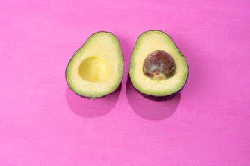 Avocado halves on colorful background
