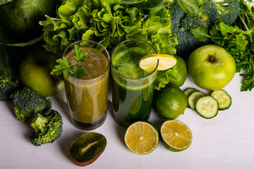 Green smoothie kiwi and cauliflower drinks on white wooden background. Raw food and drink.