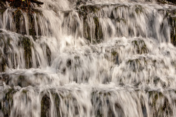 Waterfall in the wild rain forest. Natural water background.