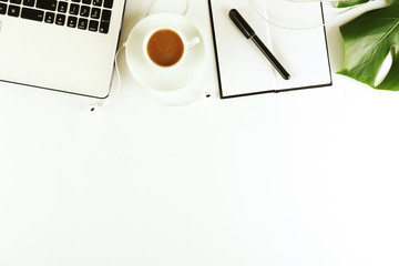 Female blog writer workspace concept. Big green monstera palm leaf on femenine desktop composition....