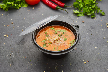 Traditional Georgian soup Kharcho with meat and rice on dark stone background