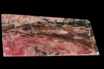 Fototapeta premium Macro stone Rhodonite mineral on a black background