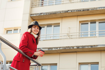 Businesswoman drinks coffee in a sunny day