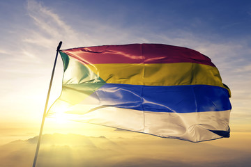 Druze flag waving on the top sunrise mist fog