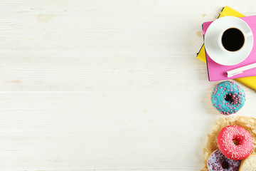 Vibrant composition of lush donut with colorful sprinkled icing, on bright background with a lot of copy space for text. Tasty but unhealthy food concept. Close up, flat lay, top view.
