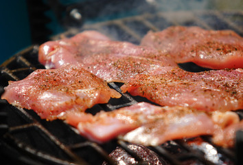 Grilling spicey meat on grill