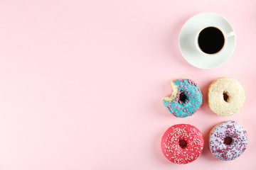 Vibrant composition of lush donut with colorful sprinkled icing, on bright background with a lot of...