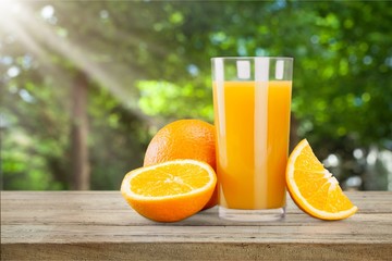 Orange juice and slices of orange on background
