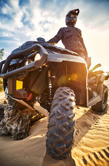 Racing in the sand on a four-wheel drive quad. © Bondariev Volodymyr.
