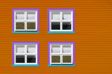 Purple and blue windows on orange wall