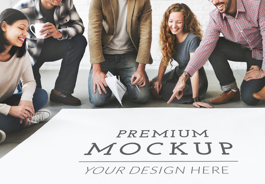 5 People in Front of a Lage Piece of Paper Mockup