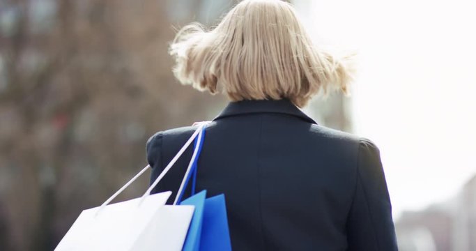 Camera following a woman on a shopping trip