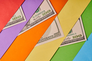 A few American dollars on a colored paper background