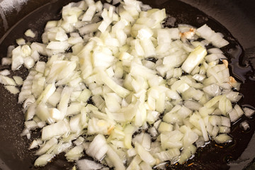 Fried onions in oil. Close up