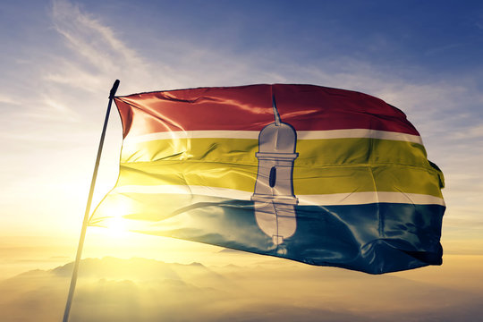 Macapa city of Brazil flag waving on the top sunrise mist fog