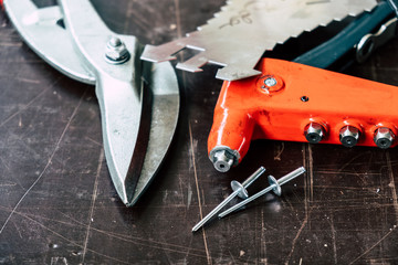Tinsmith tools on the working table in the factory