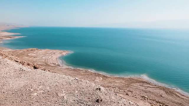 Dead Sea coastline with salt beach and mountains, Israel, Middle East. Crane shot.
