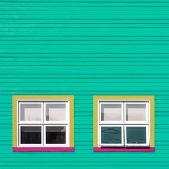 Yellow and pink window on green wall