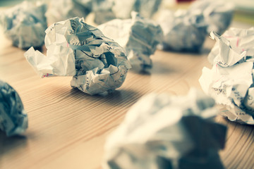 Many crumpled white paper balls on wooden table. Texture of crumpled paper balls.  Crumpled paper...