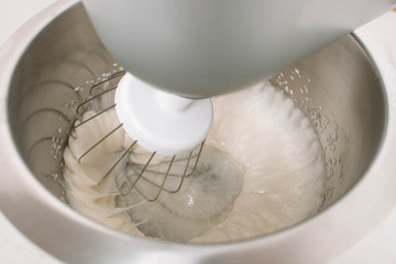 The mixer whisk heaps eggs and sugar to make marshmallow. Homemade marshmallow recipe